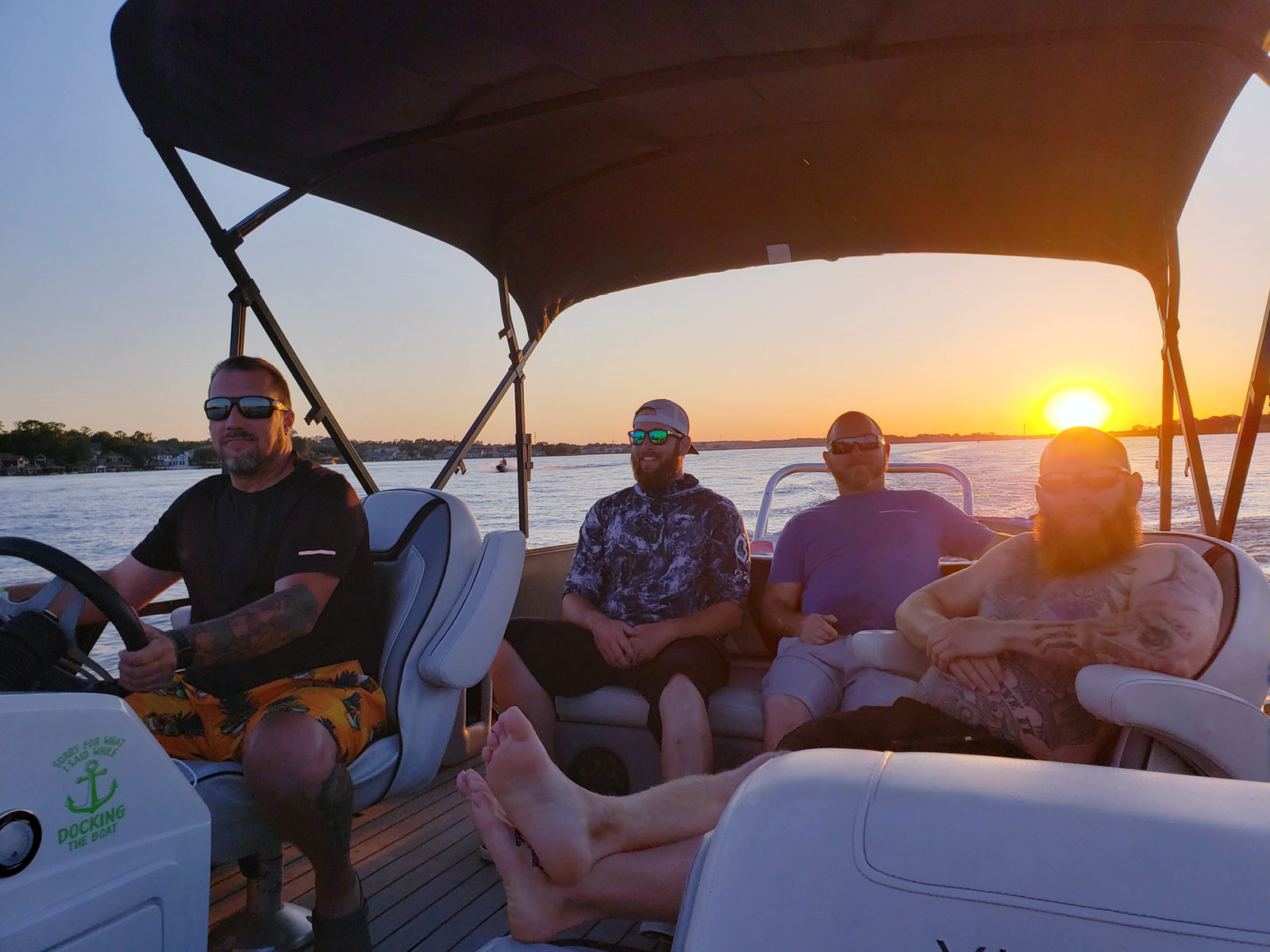 Friends cruising Lake Conroe at golden hour on a Funday pontoon